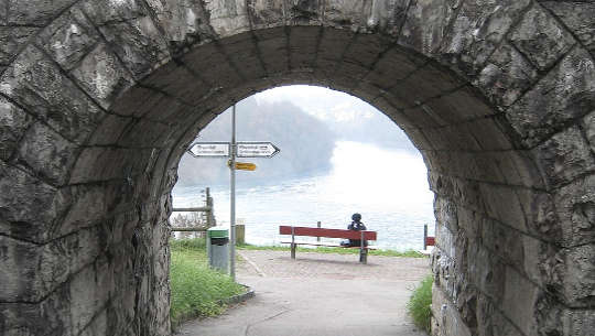 What Will You Do With Your Life Now? person sittin on a bench at the end of a tunnel with signposts pointing left or right