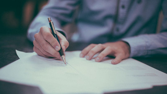 Make Your Dreams Come True—One Step at a Time man sitting down writing
