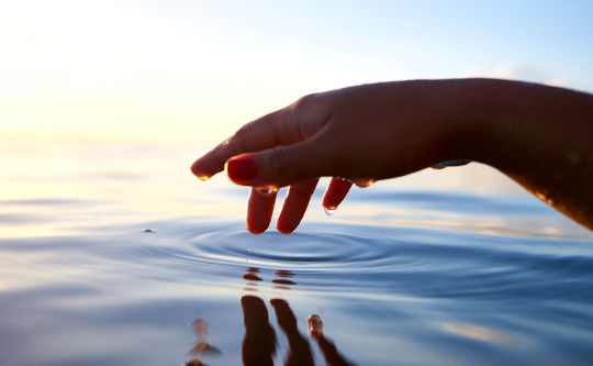 Today's Inspiration: November 2, 2022 a hand making a ripple in the ocean