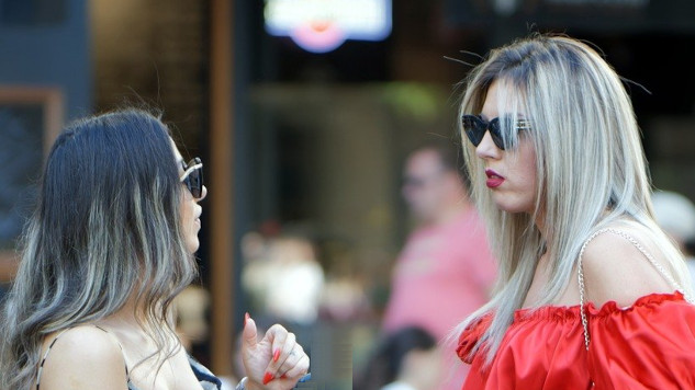 Four Good and Bad Communication Habits two women wearing sunglasses standing in front of each other talking
